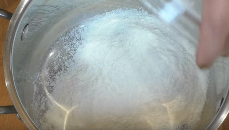 pour flour into the stewpan.