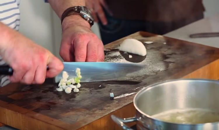 Finely chop the white part of the green onion.