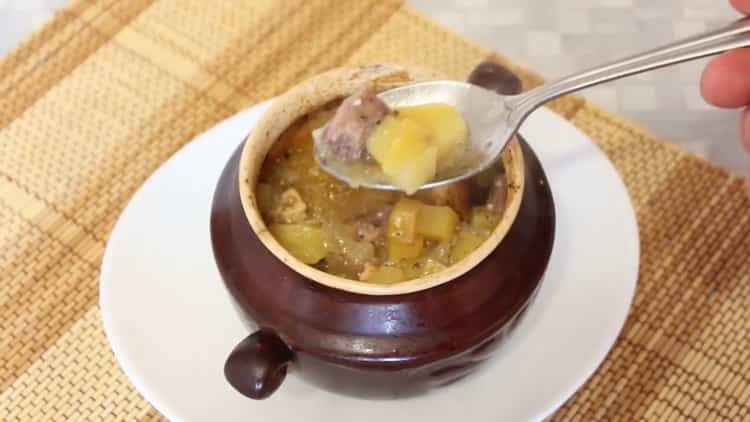 beef in pots with potatoes in the oven is ready