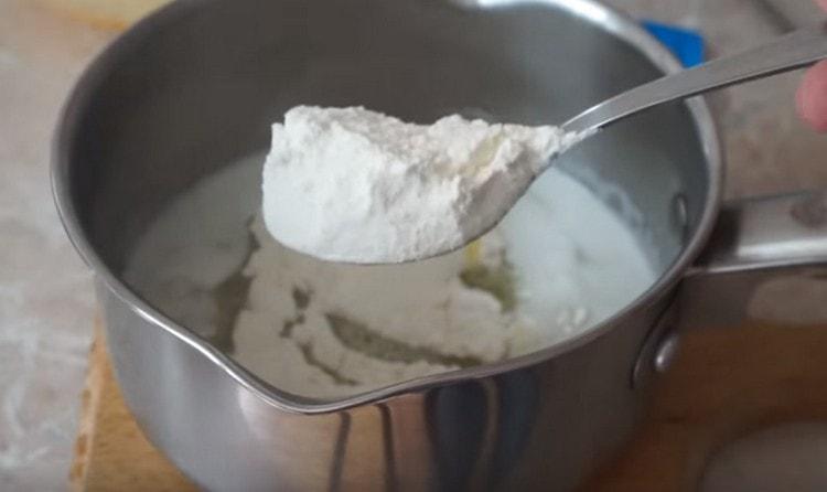 Add 2 tablespoons of flour to the hot oil.