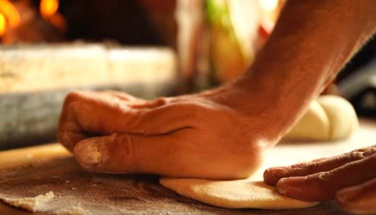 divide the dough into small pieces and roll them out with a rolling pin or knead with your hands.