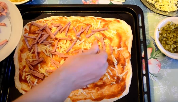 Next, lay the sausage chopped into strips.