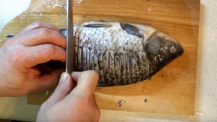 We make cuts on the fish.