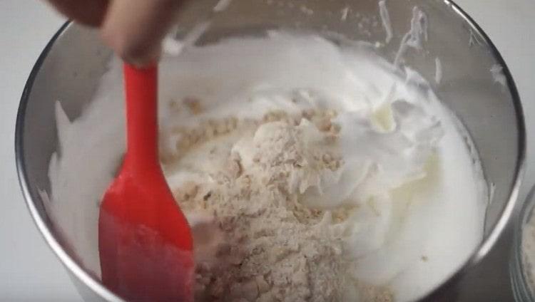 In parts, we add a nut-flour mass into the whipped proteins.