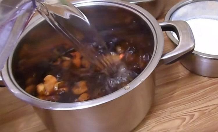 Transfer dried fruits to the pan and add water.