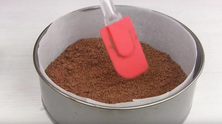 Pour a third of the crumbs to the bottom of the mold and level.