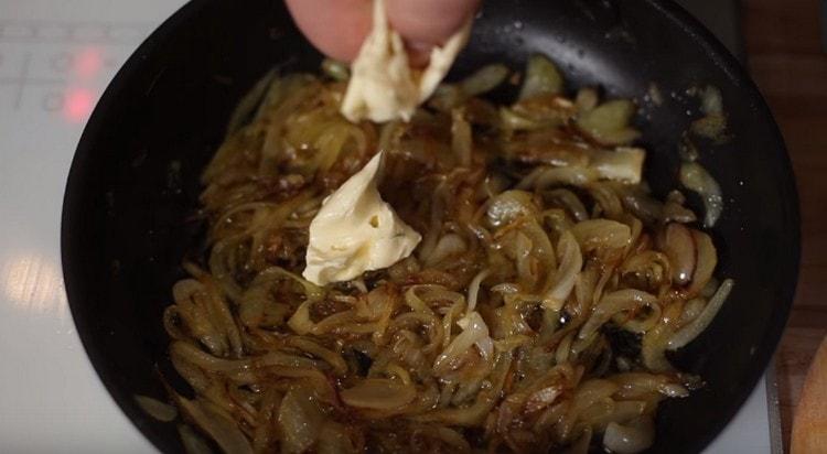 When the onion turns brown, add a piece of butter to it.