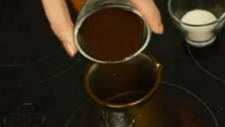 Pour fresh coffee into the Turk.