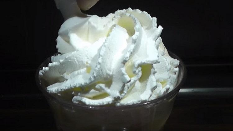 Using a pastry bag or syringe, squeeze whipped cream.