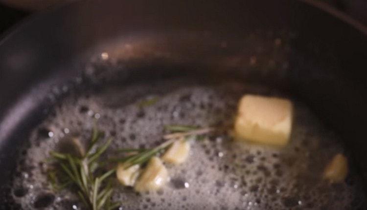 Add garlic and a sprig of rosemary to the oil.