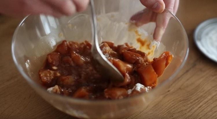 Add the flour to the chicken and mix.