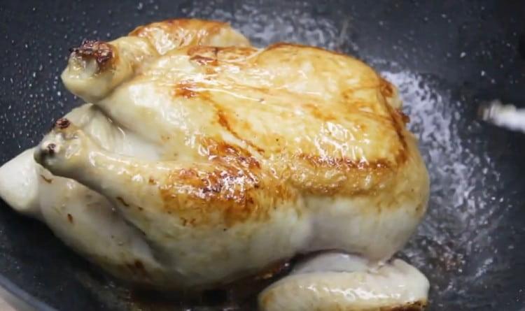 Turn the carcass over to fry it on the other side.