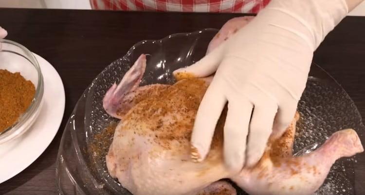 Rub the chicken thoroughly with spices.
