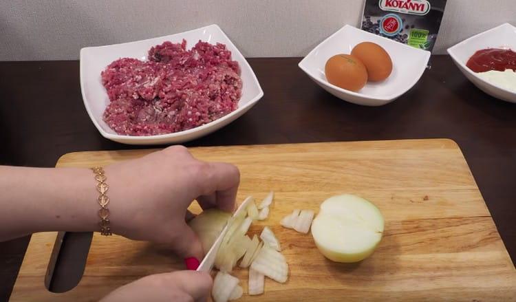 three carrots on a grater, chop the onion.