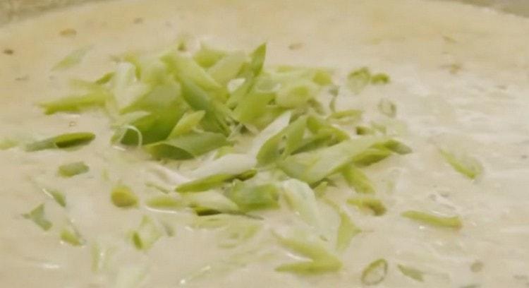 Then add the finely chopped green onions.