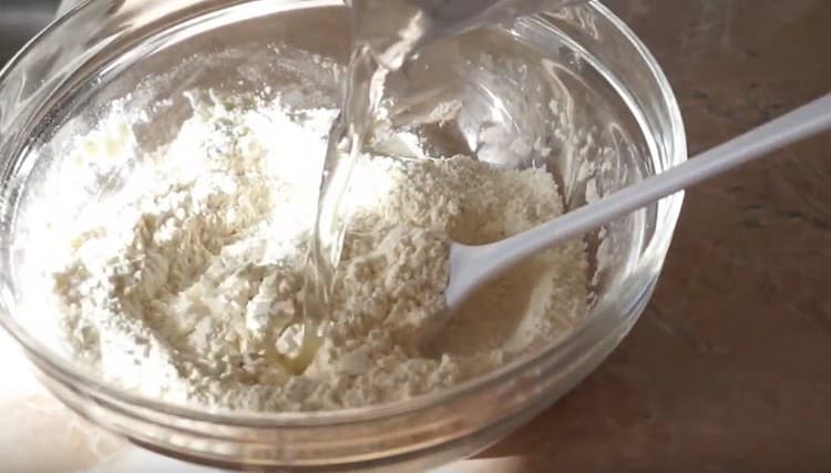 Add water to the dry ingredients.