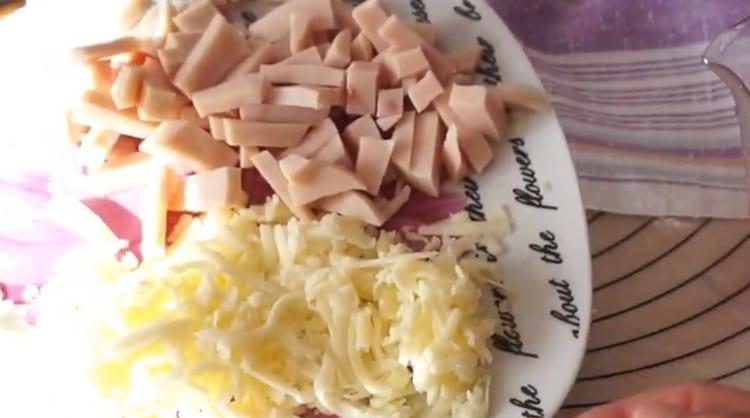 Grate the cheese, cut the ham into a cube.