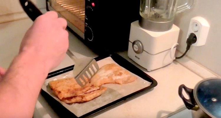 Then we transfer the fish to a baking sheet covered with parchment.