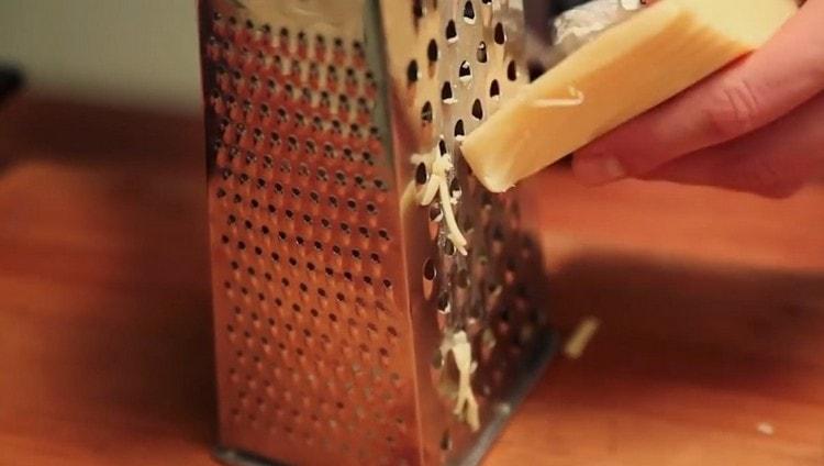 While the meat is baked, we grate hard cheese.