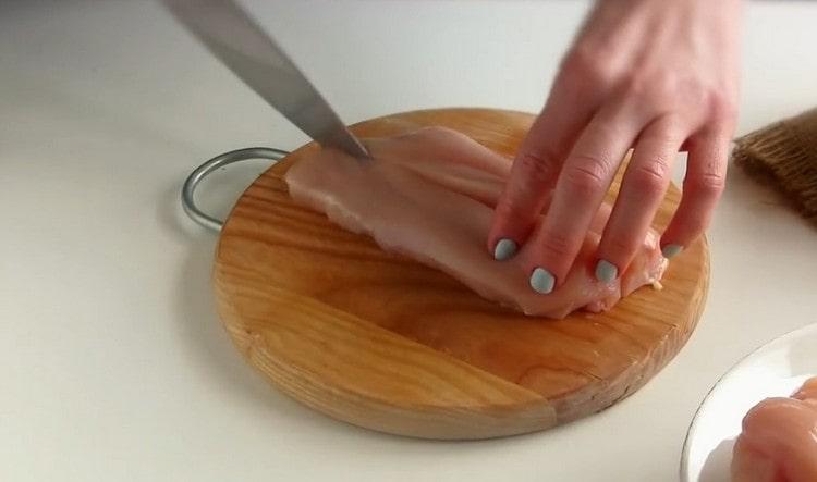 Cut the chicken in half.