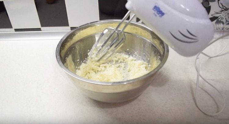 Beat softened butter with sugar with a mixer.