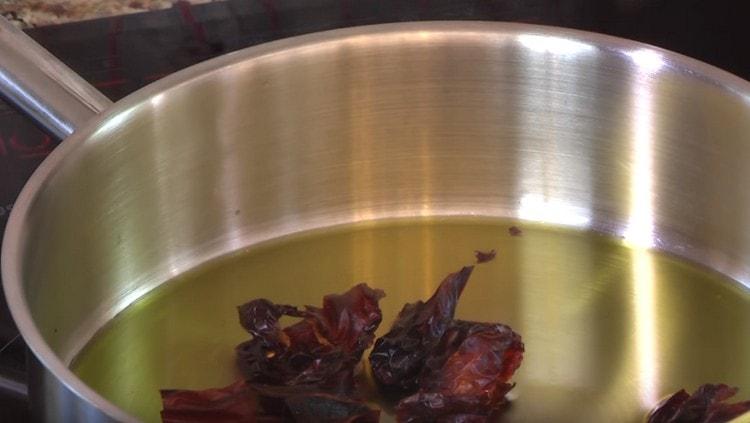 Lightly fry peppers in hot oil.