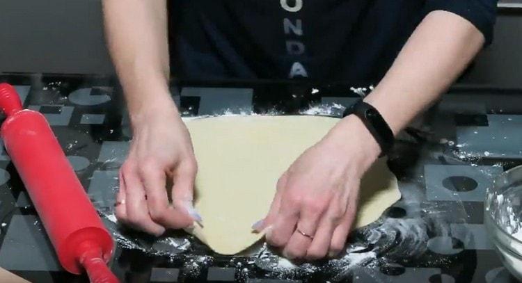 Thinly roll out a piece of dough.