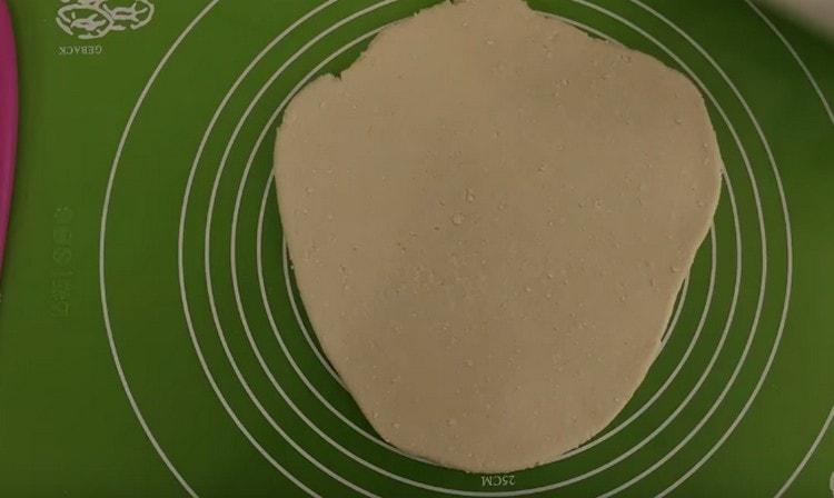 Roll out a piece of dough.