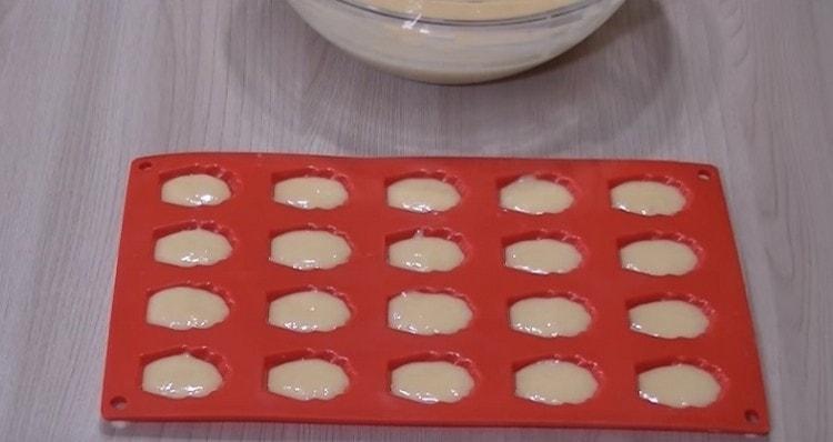 We spread the dough in special molds for madeleines.