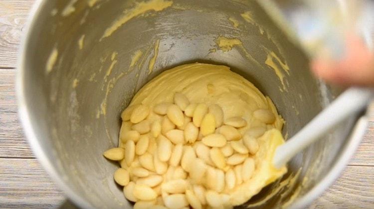 Put the almonds in the dough.