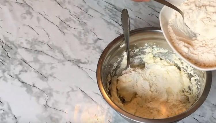 In parts, we begin to introduce sifted flour into the dough.