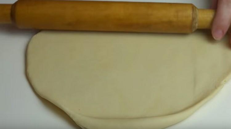 Roll out the dough and cut out the cookies.