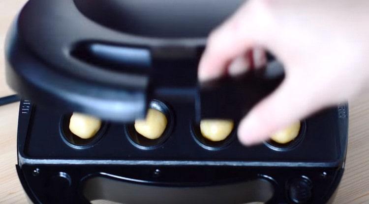 Put the balls in a mold, close and bake until golden brown.