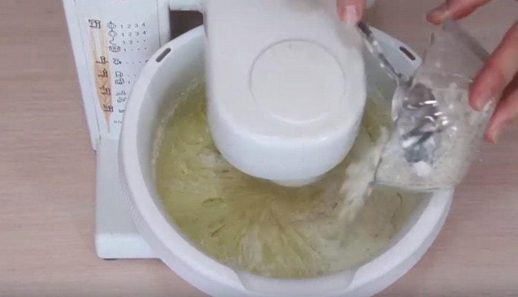 In portions, we introduce flour into the egg mass.