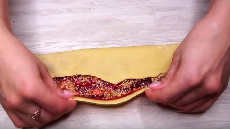 We turn the edges of the dough to the center, making a roll