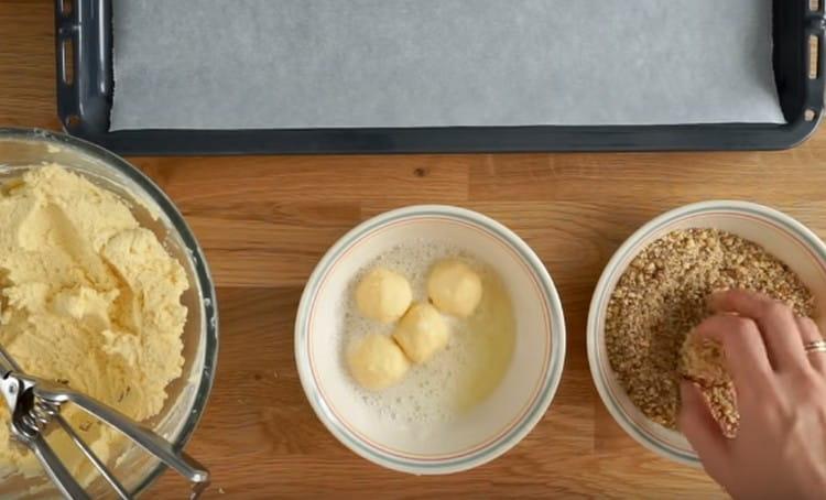 After the proteins, we transfer the workpieces into nut crumbs and roll.