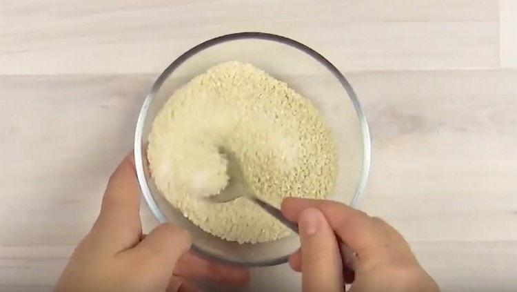 Mix sesame seeds with sugar.