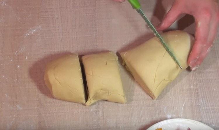 We take out the dough from the refrigerator and divide it into parts.