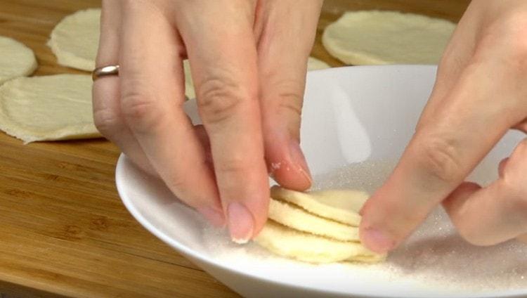 Dip the workpiece again in sugar and fold it in half again.