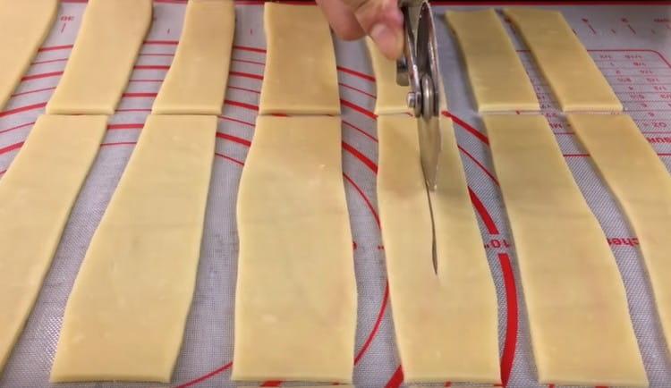 We cut the strips into 3 parts each and make cuts in the center of the blanks.