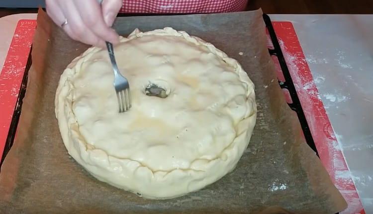 In the center of the pie, make a hole for steam to escape, prick the pie in several places with a fork.