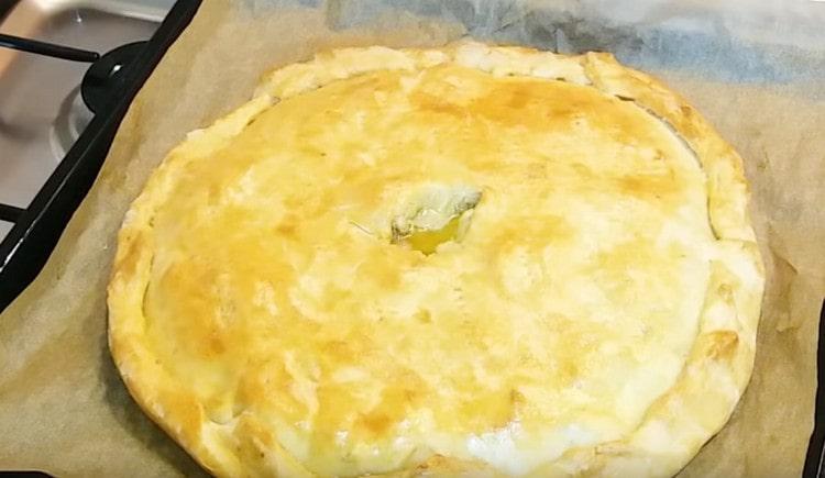 Pie with potatoes and mushrooms turns rosy and juicy.