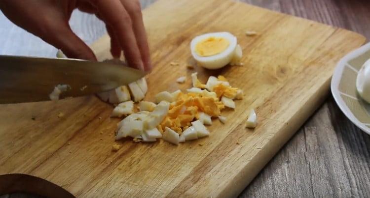 Crush the boiled eggs.