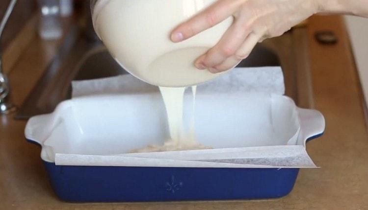 Most of the dough is poured into a mold.