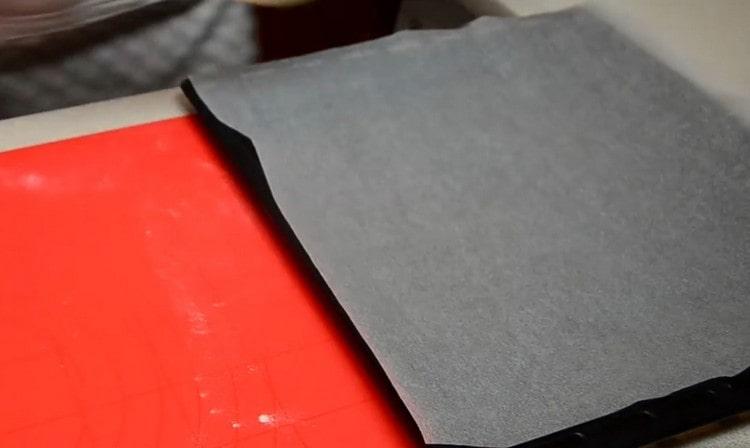 We cover the baking sheet on which we will bake the cake with parchment.