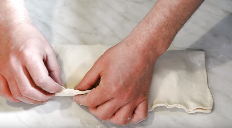 Cover the filling with the second half of the dough and pinch the edges.