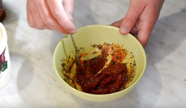 Cooking spicy sauce with herbs.