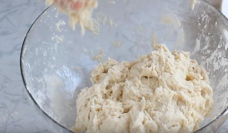 Add water and knead a sticky dough.