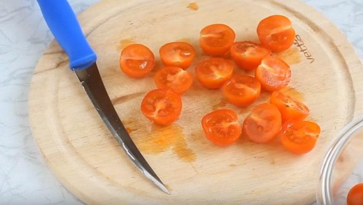 Cherry tomatoes are cut in half.
