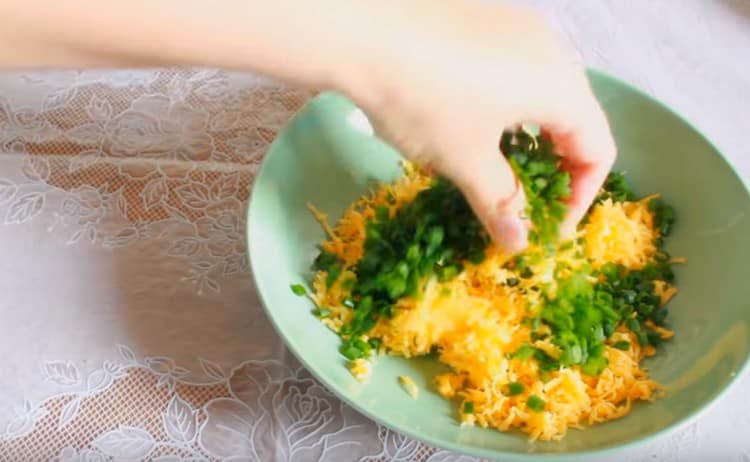 While the pizza is cooked, mix the cheese with chopped onions.